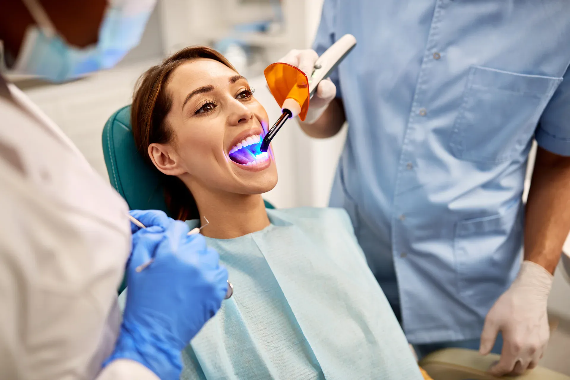 Gentle laser dentistry treatment for a smiling patient